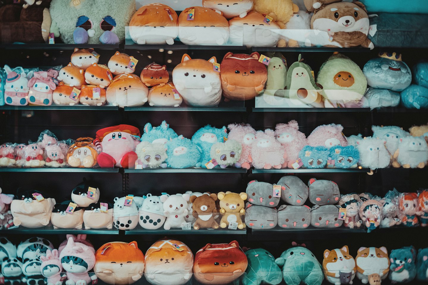 Colorful animal plush toys arranged on store shelves.